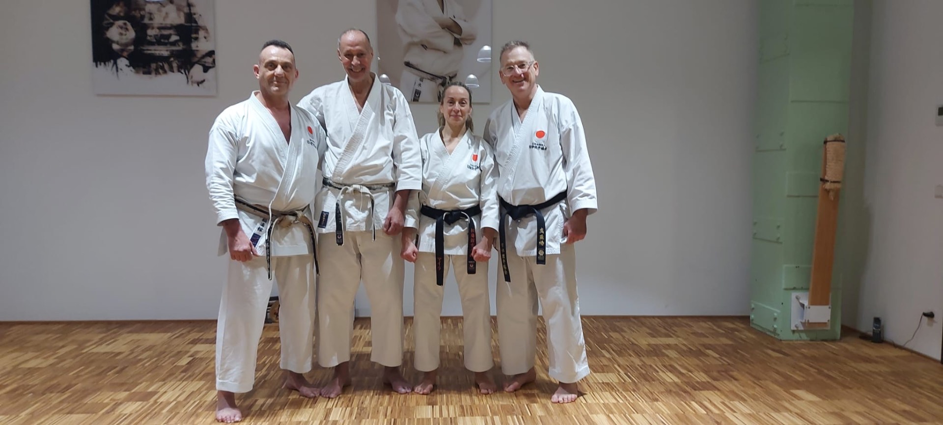 Vier Karateka mit Dan-Graden im Dojo